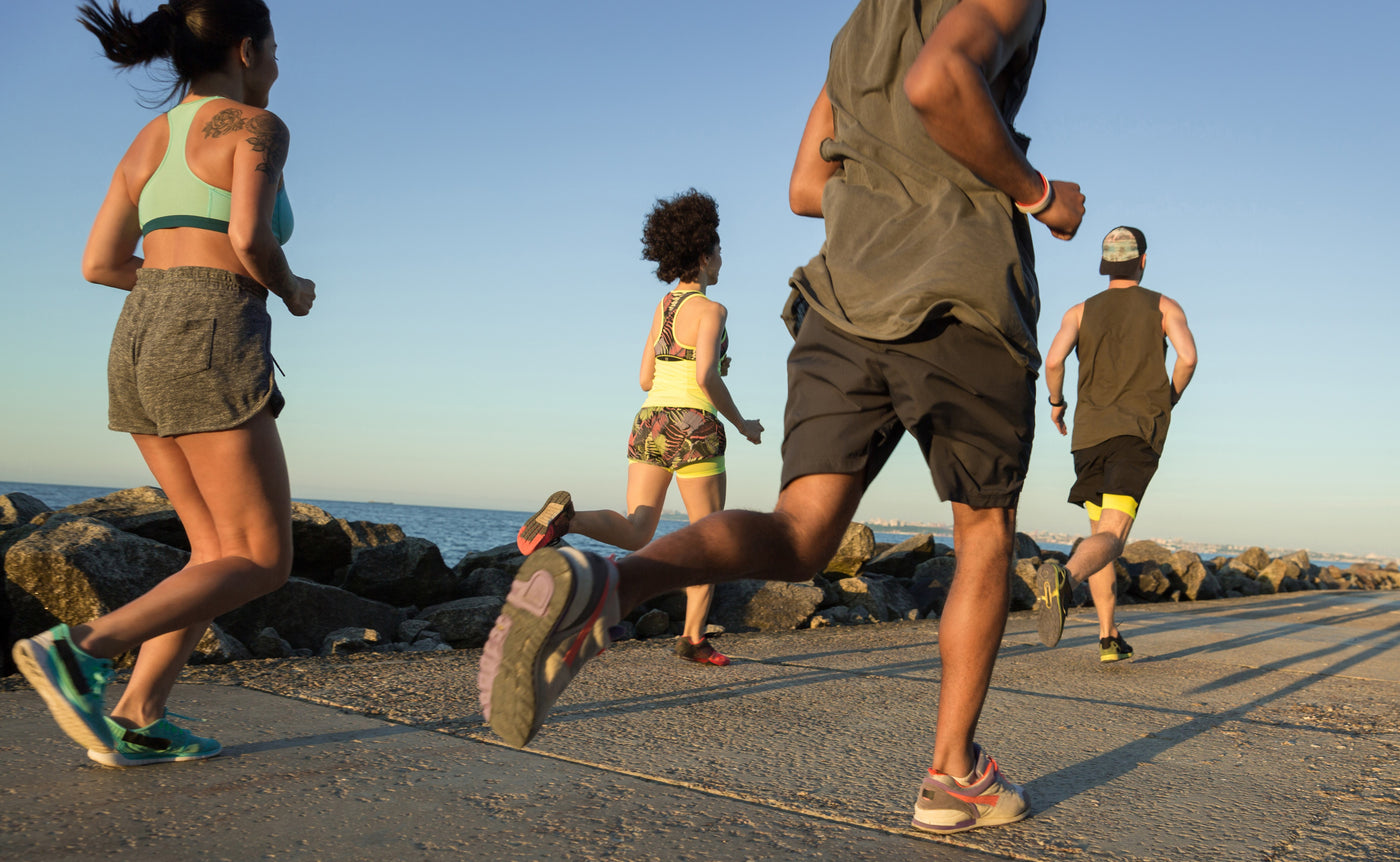 Young Runners Sprinting Along Beach Coastline