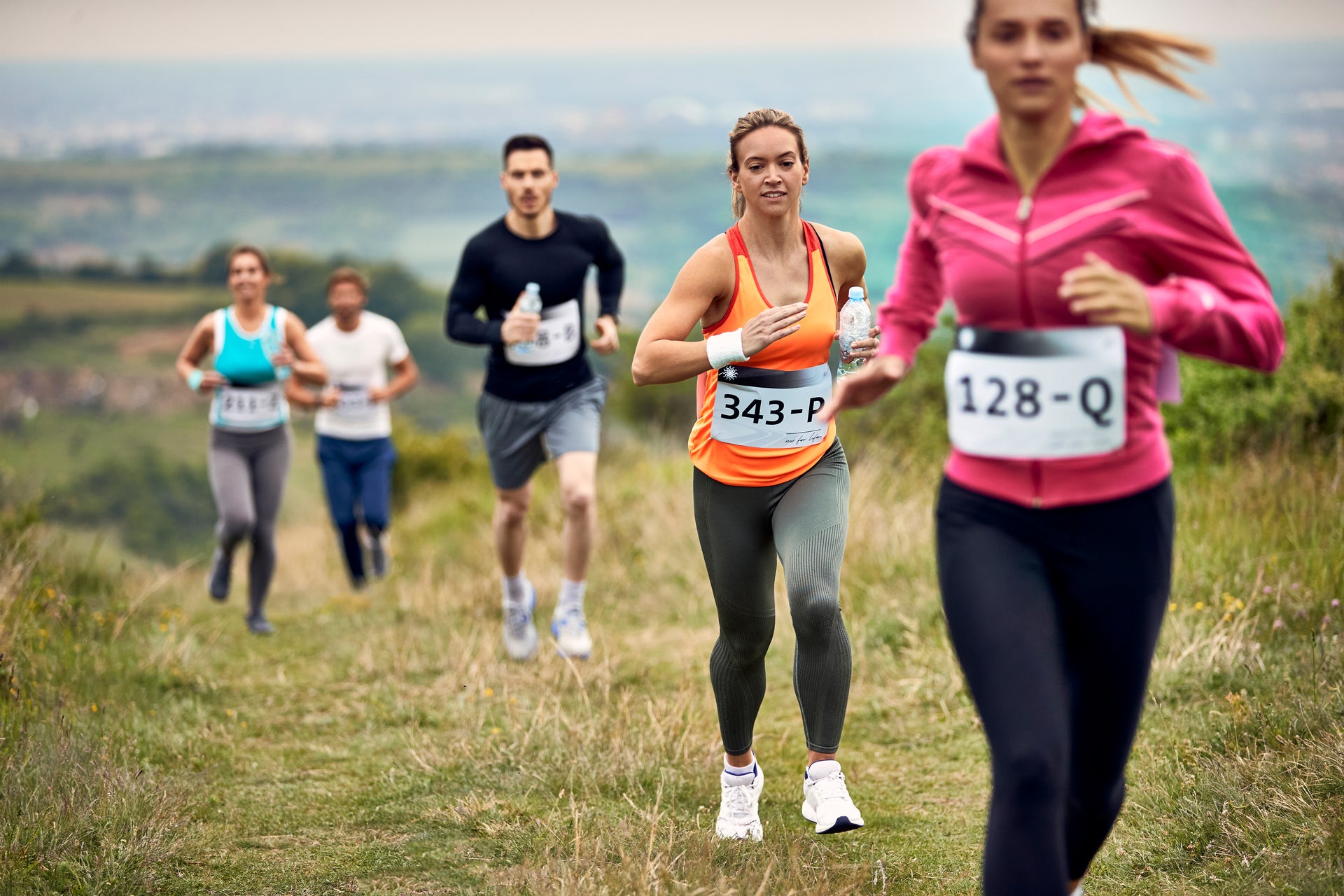 Group of Athletic People Running Marathon in Nature